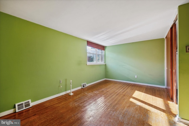 spare room with hardwood / wood-style flooring