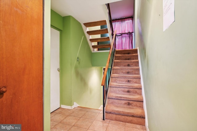 staircase featuring tile patterned flooring