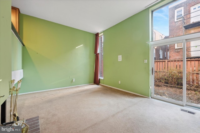 unfurnished living room with light colored carpet