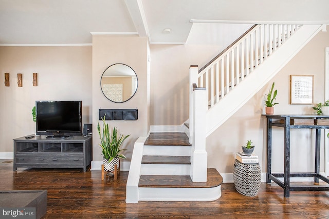 stairway featuring hardwood / wood-style floors and crown molding