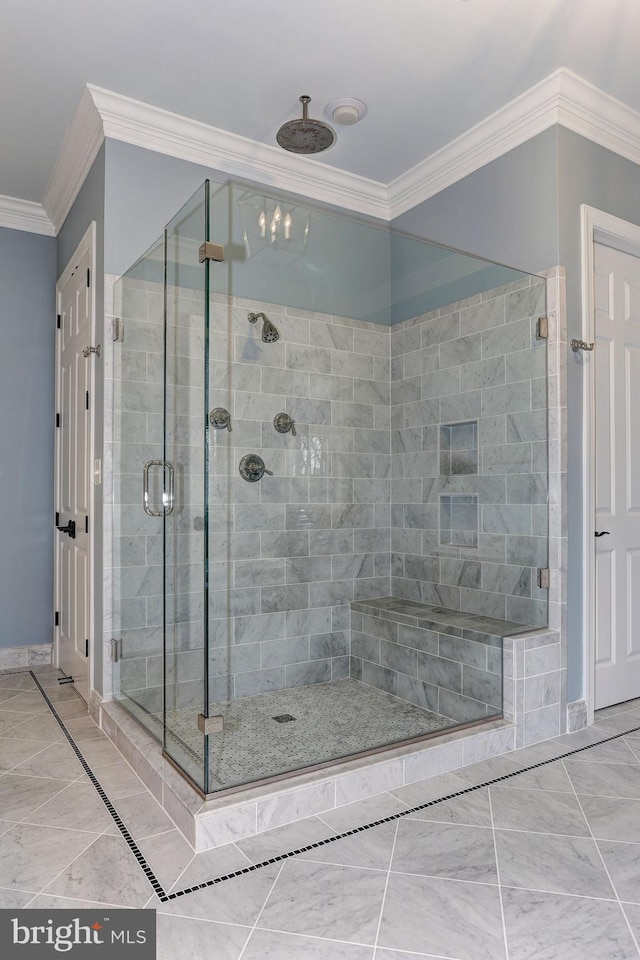 bathroom with crown molding and an enclosed shower