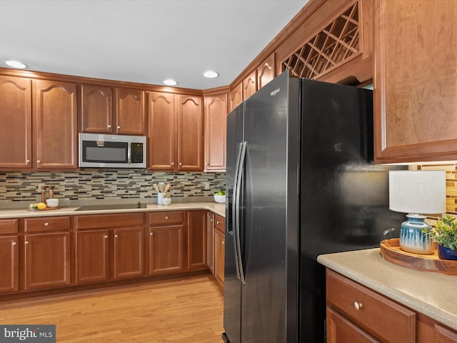 kitchen featuring light hardwood / wood-style flooring, tasteful backsplash, and stainless steel appliances