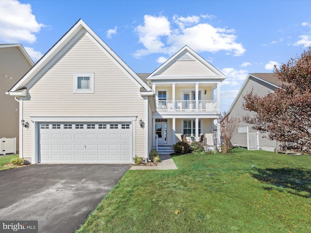 view of front of property with a garage, a front yard, and a balcony