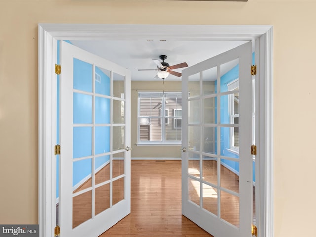 doorway to outside with french doors, wood-type flooring, and ceiling fan