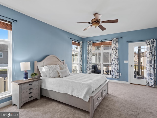 bedroom featuring multiple windows, ceiling fan, and access to exterior