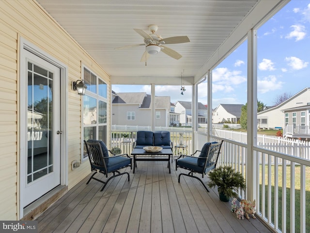 sunroom featuring ceiling fan