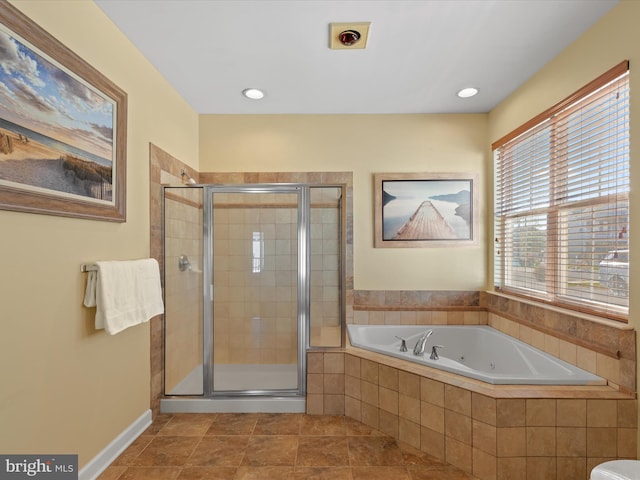 bathroom with tile patterned flooring and shower with separate bathtub