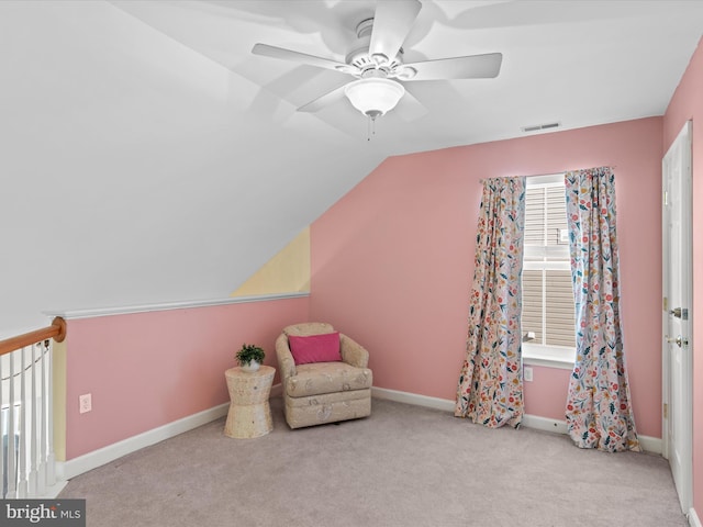 living area with ceiling fan, light carpet, and vaulted ceiling