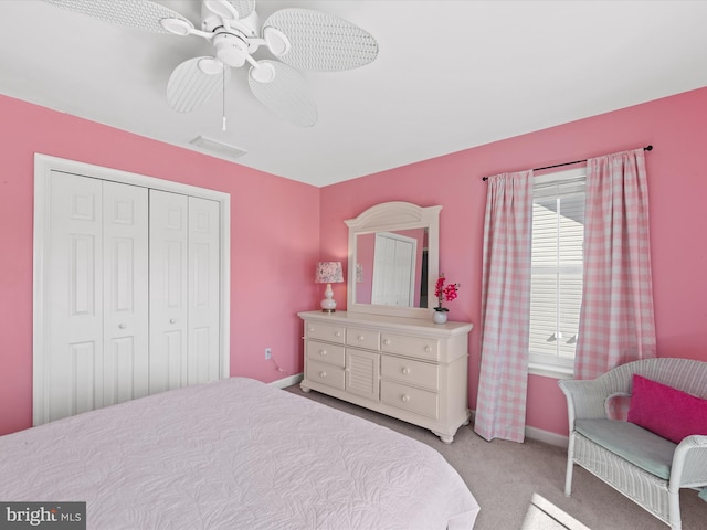 carpeted bedroom with ceiling fan and a closet