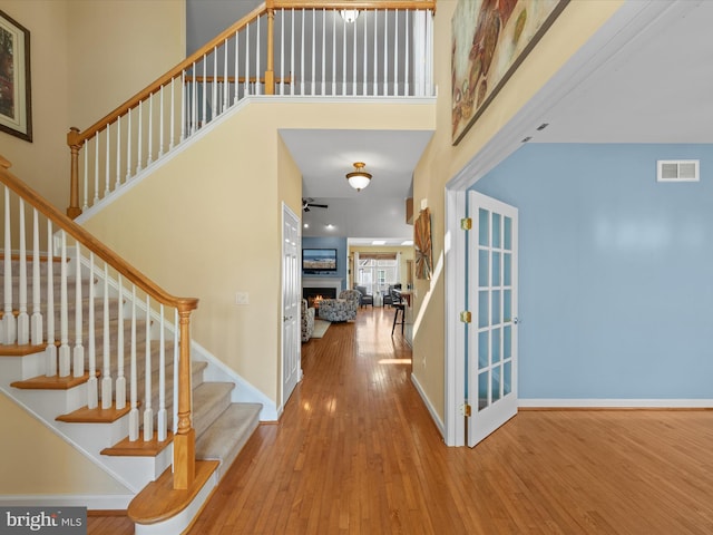 foyer entrance with a high ceiling and hardwood / wood-style floors