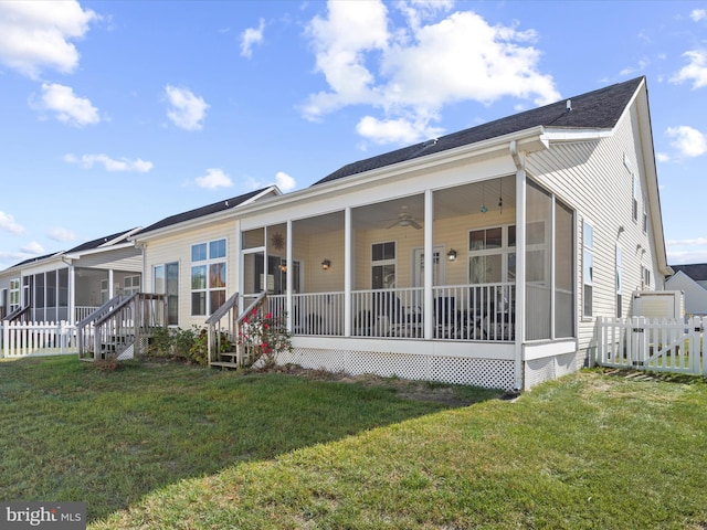 view of front of property with a sunroom, a front yard, and ceiling fan