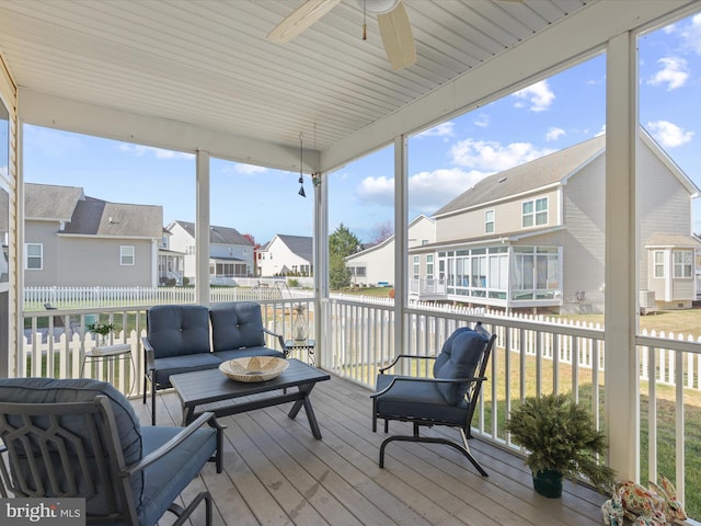 sunroom / solarium featuring ceiling fan