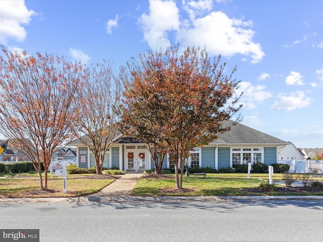 view of front of property with a front lawn and french doors