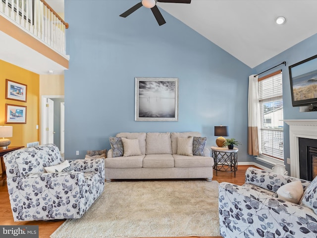 living room featuring high vaulted ceiling, ceiling fan, and light hardwood / wood-style flooring