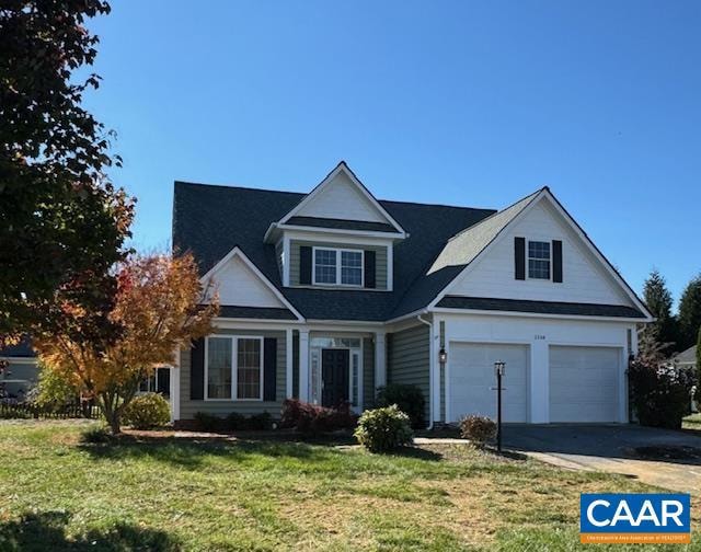 view of front of property with a garage and a front lawn