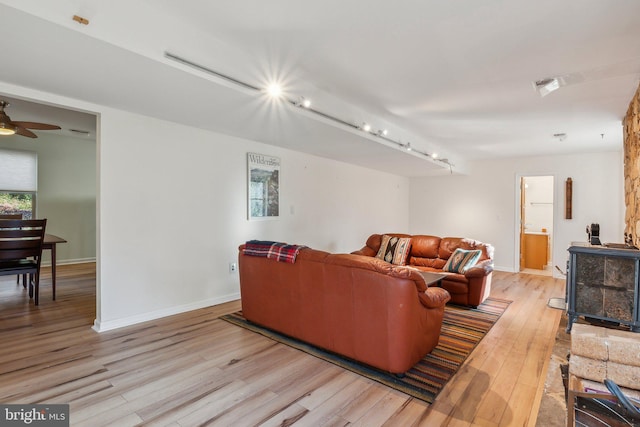 living room with light wood-type flooring and ceiling fan