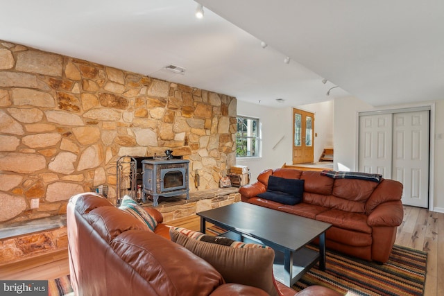 living room with light wood-type flooring and a wood stove