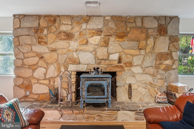 room details featuring a wood stove and hardwood / wood-style floors