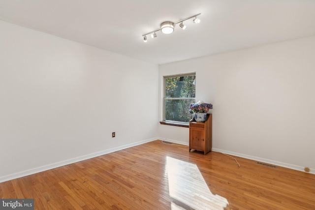 spare room with light hardwood / wood-style floors