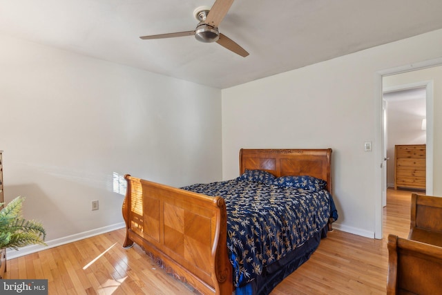 bedroom with light hardwood / wood-style flooring and ceiling fan