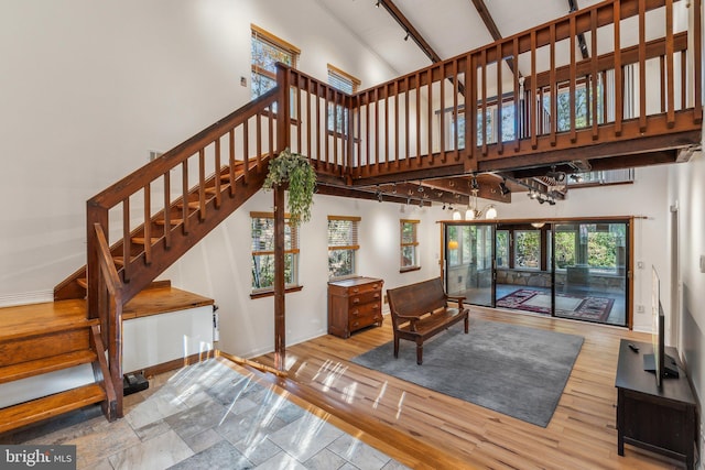 interior space with high vaulted ceiling, light hardwood / wood-style flooring, and beamed ceiling