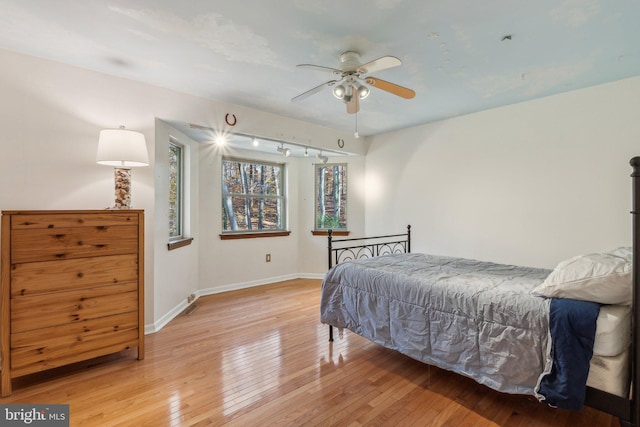 bedroom with light hardwood / wood-style floors and ceiling fan