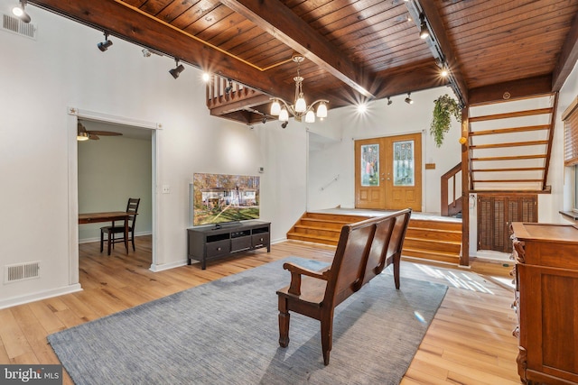 living room featuring hardwood / wood-style flooring, rail lighting, beam ceiling, wood ceiling, and french doors