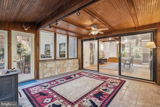 sunroom featuring track lighting, lofted ceiling, ceiling fan, and wood ceiling