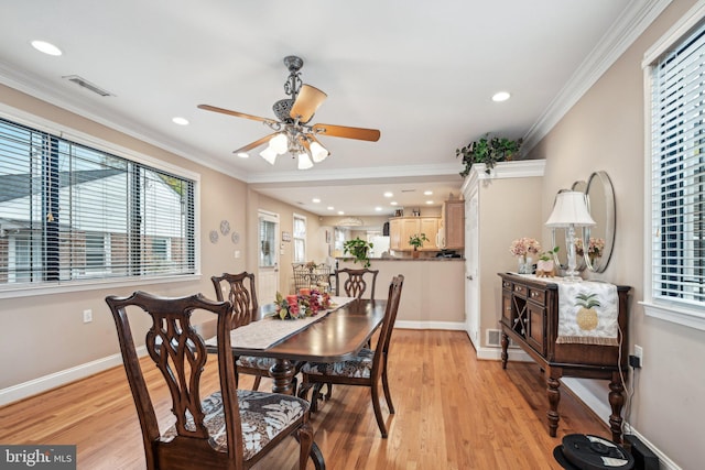 dining area featuring crown molding, light hardwood / wood-style flooring, and ceiling fan