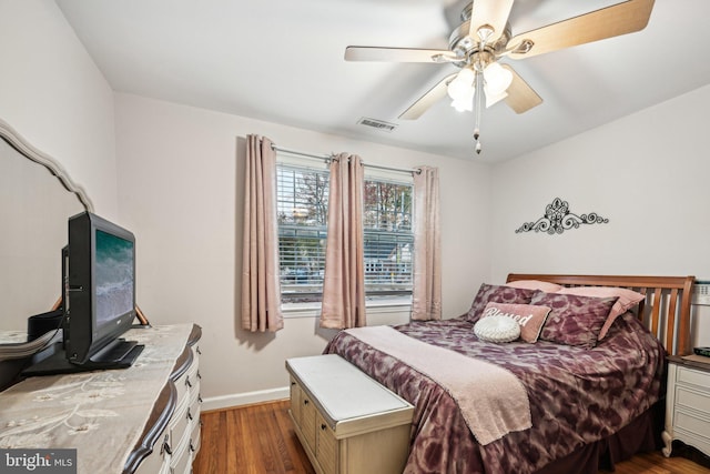 bedroom with dark wood-type flooring and ceiling fan