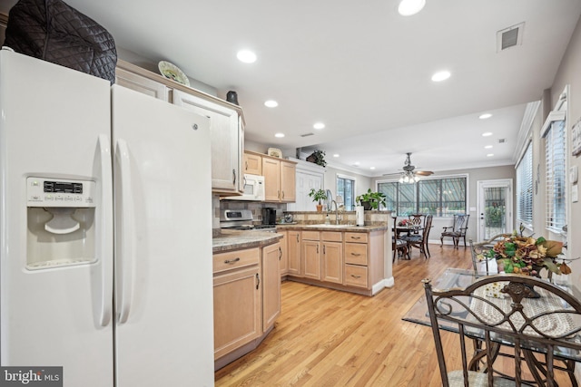 kitchen with white appliances, backsplash, ornamental molding, light brown cabinetry, and light hardwood / wood-style floors