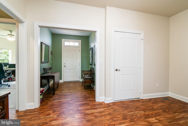 foyer entrance with dark hardwood / wood-style floors and ceiling fan