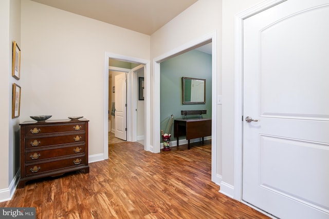 hallway with dark hardwood / wood-style floors