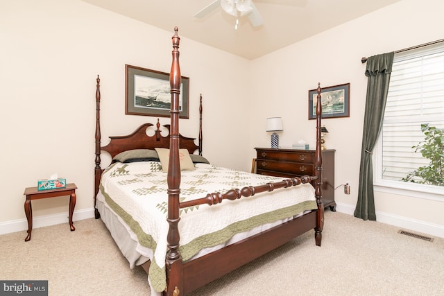 bedroom featuring light colored carpet and ceiling fan