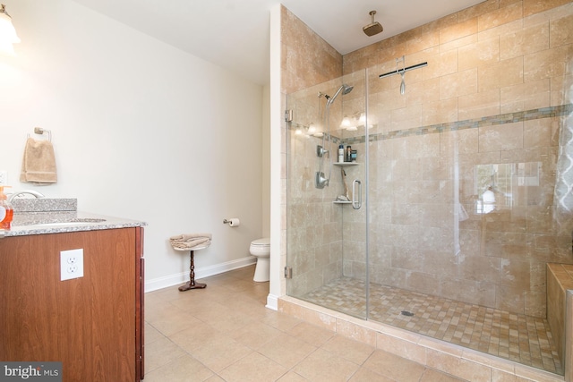 bathroom with toilet, an enclosed shower, vanity, and tile patterned floors