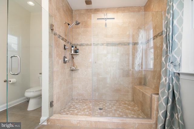 bathroom featuring tile patterned flooring, toilet, and a shower with curtain