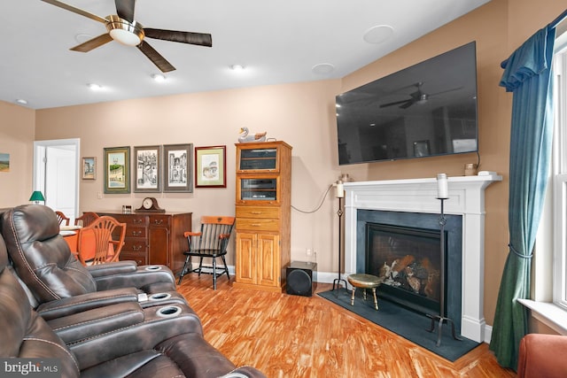 living room with ceiling fan and light wood-type flooring