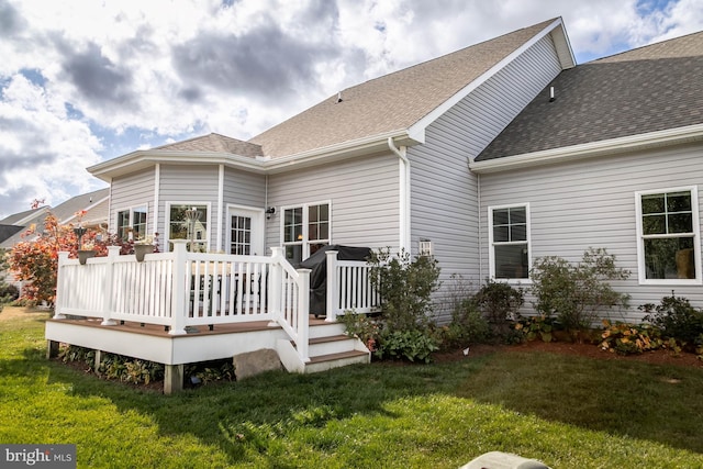 back of house with a yard and a deck