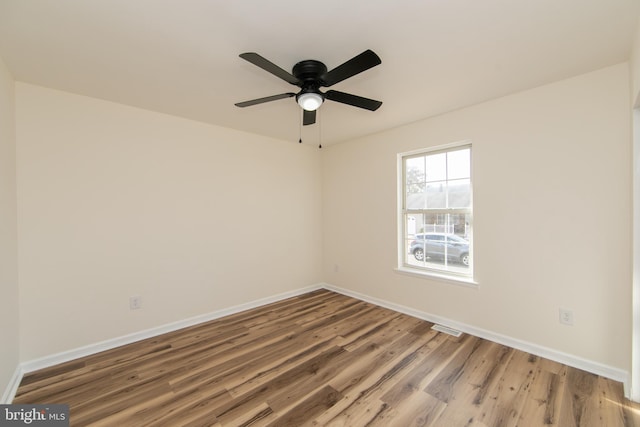 spare room featuring hardwood / wood-style floors and ceiling fan