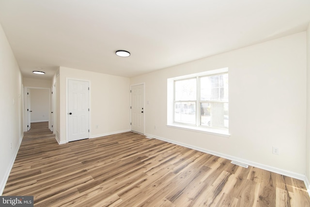 spare room with light hardwood / wood-style floors