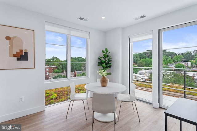 dining area with light hardwood / wood-style floors