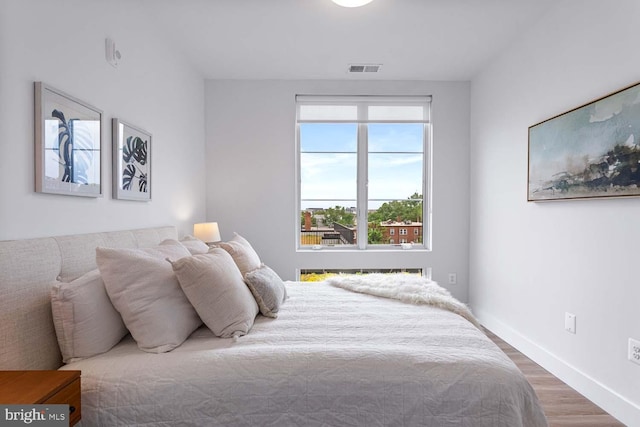 bedroom with wood-type flooring