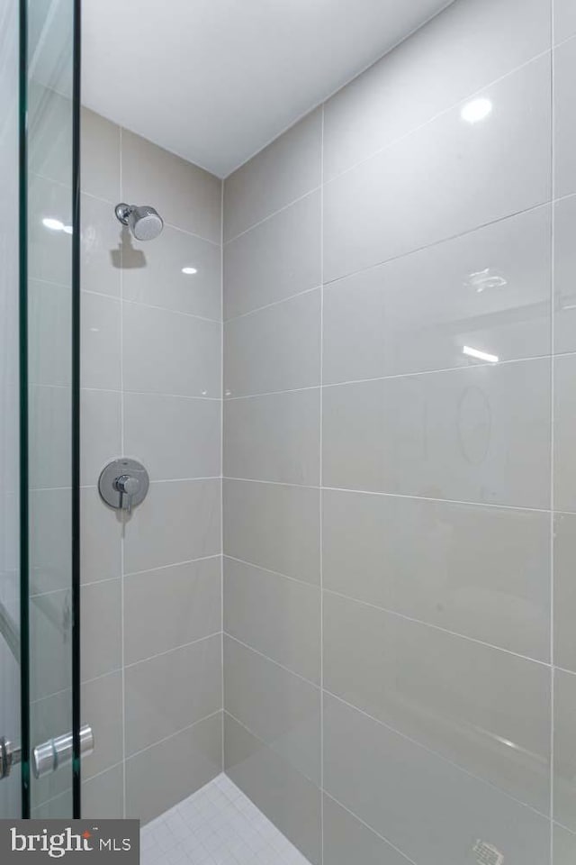 bathroom with tiled shower