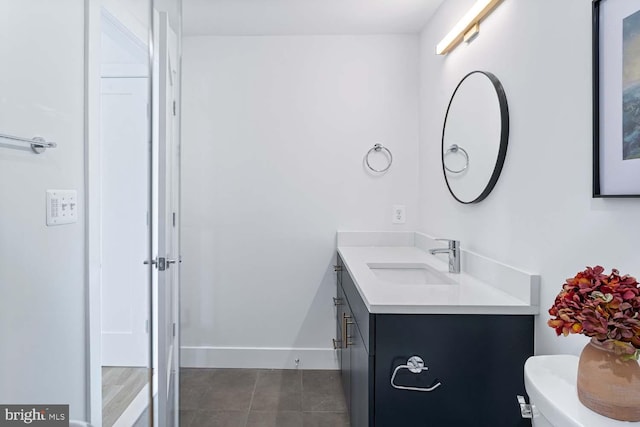 bathroom featuring toilet, vanity, and tile patterned floors