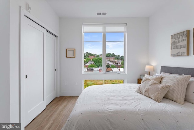 bedroom with a closet and light hardwood / wood-style floors