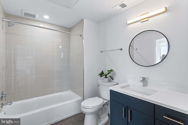 full bathroom with toilet, tiled shower / bath combo, vanity, and tile patterned flooring