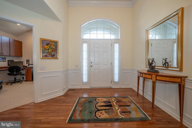 entryway featuring crown molding and dark hardwood / wood-style flooring