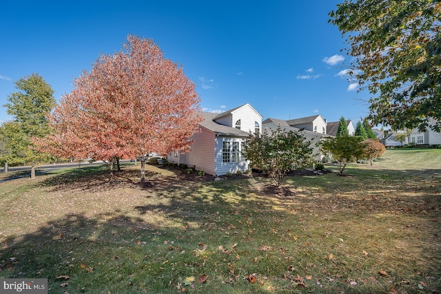 view of home's exterior with a lawn