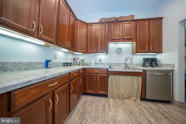 kitchen with dishwasher, light wood-type flooring, light stone counters, and sink