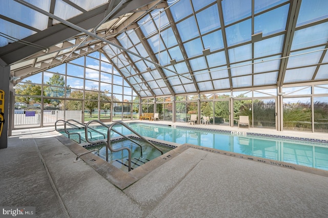 view of pool featuring glass enclosure, an indoor in ground hot tub, and a patio